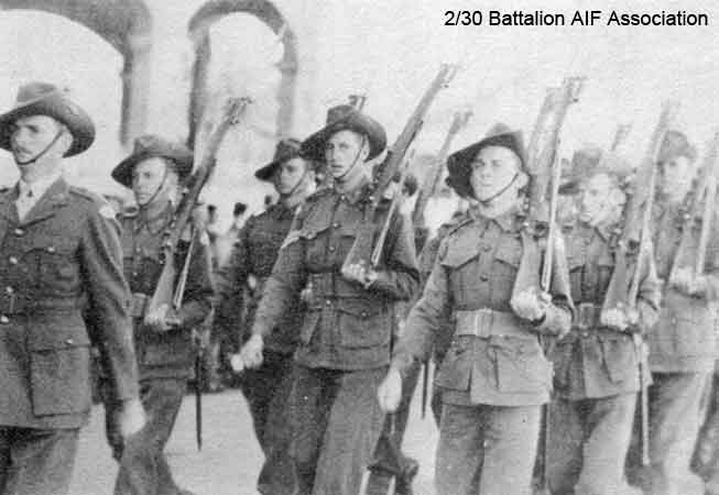 A Company, 7 Platoon
"A" Company march through Bathurst in 1941.

Left to right:
1) NX70458 - MASTON, Ronald Harry (Bomb Happy), Capt. - C Coy. 2 l/c
2) NX29973 - HALL, Rex Turnbull Sinclair (Sammy), A/L/Sgt. - A Coy. 7 Pl.
3) NX41357 - CAMERON, Alan Rentoul, Lt. - C Coy. O/C 15 Pl. to Malaya OCTU 15/9/1941, Lt 12/12/1941
4) NX34417 - ROSS, Ernest Stanley, Cpl. - A Coy. 7 Pl. WiA Gemas
5) NX51313 - MADDEN, James Ross Harrington (Ross), Pte. - A Coy. 8 Pl.
6) NX27118 - COLLINS, Henry Edward (Harry), Cpl. - A Coy. 7 Pl.
7) ?
