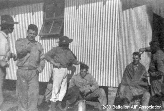 Camp barbering
"A" Company having a haircut at Bathurst.

Left to right:
1) NX29925 - BELL, Walter Lind (Wally Mark 1), L/Cpl. - A Company, 8 Platoon
2) NX34442 - CLYNE, Patrick James (Paddy), Pte. - A Company, 8 Platoon
3) NX32426 - CODY, Horace Noel (Horrie), Pte. - A Company, 8 Platoon
4) NX26692 - BLOMFIELD, Alfred Lindsay (Curly), L/Cpl. - A Company, 8 Platoon
5) NX56543 - HAYES, Francis Joseph (Bully or Frank), Pte. - A Company, 8 Platoon
6) NX33384 - SKUSE, Edward Frederick (Ted), Cpl. - A Company, 8 Platoon
