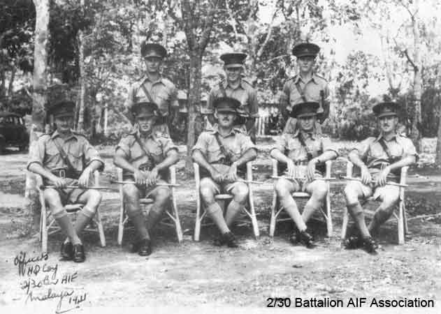 HQ Company Officers
In Malaya in 1941.

Left to right:

Back row (standing):
1) NX12530 - COOPER, James Herbert (Jim), Lt. - HQ Company, 2 I/c Carrier Platoon
2) NX70448 - FARR, Albert Irwin (Bub), Lt. - HQ Company, O/C Signals Platoon
3) NX70447 - KRECKLER, John Francis (Bib), Lt. - HQ Company, 2 I/c Mortar Platoon

Front row (seated):
1) NX70426 - MACAULEY, Norman Gilmour (Red), Capt. - HQ Company, O/C Transport Platoon
2) NX12540 - BOSS, John Albert, Lt. (later Capt.) - A Company, 2 I/c
3) NX70427 - JOHNSTON, Noel McGuffie (Charlie Chan), Major (later Lt. Col.) - BHQ, 2 I/c
4) NX12548 - PRYDE, John Alan (Gula), Capt. - BHQ, QM.
5) NX12542 - TOMPSON, Richard Clive (Dick), Capt. - HQ Company, O/C Carrier Platoon
