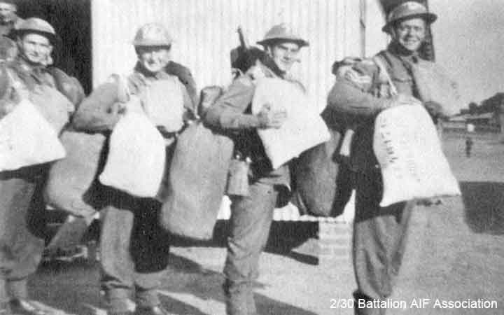 Training in Bathurst
"D" Company doing pre-embarkation training at Bathurst in July, 1941.

Left to right:
1) NX47853 - NAPPER, Reginald (Reg), WO2 - D Company, 16 Platoon (in doorway)
2) ?
3) NX46072 - FORRESTER, Harold Joseph (Harley), Pte. - D Company, 16 Platoon
4) ?
5) NX46176 - ABBOTTS, Frederick (Fred), A/U/Sgt. - D Company, 16 Platoon
Keywords: Makan267