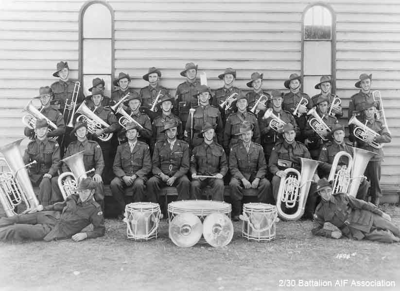 2/30 Battalion Band
2/30 Battalion Band
Back Row (L to R):
1) NX68238 - DESMET, Stanley Joseph (Bill), Pte. - Trombone - "F" Force
2) NX68235 - COPLEY, Francis Peter, Pte. - Solo Cornet - "F" Force
3) NX68236 - LUGTON, Stanley James (Stan), Cpl. - Solo Cornet - "F" Force
4) NX36270 - ELPHICK, James Jack (Jack), Pte. - Solo Cornet - "F" Force
5) NX67631 - WATTERSON, Rowland Hubert (Roly), Sgt. - G Trombone - Died Kanburi No. 1 10/12/1943
6) NX36324 - BROUFF, Charles William (Charlie), Pte. - Cornet - "F" Force
7) NX66840 - WILKINSON, Dudley Norman, Pte. Cornet or Tenor Horn - "A" Force
8) NX68237 - HODGE, William Peter (Bill), Pte. - Cornet - "F" Force
9) NX68186 - HODGES, Alfred William James, Pte. - Cornet - Died Kami Sonkurai 16/10/1943 - "F" Force
10) ? - McLEOD, J., Pte. - Trombone

Middle row (L to R):
1) NX46929 - MIDDLETON, William (Bill), Cpl. - Eupho - Leader of Concert Party Orchestra, Changi
2) NX36142 - PARSONS, Lindsay Heyhoe, L/Cpl. - Eupho - Did not sail from Bathurst
3) NX57915 - VOLLHEIM, Eric Charles Norman, Pte. - Tenor Horn - "B" Force
4) NX53156 - BROWNBILL, Ronald Will Leonard (Bill), Pte. - Horn - Died at Tamarkan, 12/1/1944 - "A" Force
5) NX36443 - RINGWOOD, Stanley, Sgt. - Drum Major
6) NX36719 - MONTGOMERY, James William (Jim), Pte. - Side Drums - "F" Force
7) NX36267 - WHITTERON, Edward Sprowell (Ed), Pte. - Horn - Died Kuie 10/6/1943 - "F" Force
8) NX41078 - CROSSMAN, Alan Byron, Pte. - Baritone - Died at Kami Sonkurai, 16/10/1943 - "F" Force
9) NX35482 - MOUNTFORD, Laurence Gordon (Laurie), L/Cpl - Baritone - "J" Force

Front row (L to R):
1) NX69851 - RYAN, Patrick Leonard (Len), Pte. - B. B. Bass - "F" Force
2) NX36839 - EDMONDSTONE, Bertie Joseph (Bert), Pte. - B. B. Bass - Died at Shimo Sonkurai 29/8/1943 - "F" Force
3) NX34999 - RAMSAY, George Ernest, Major (Second in Command)
4) NX70416 - GALLEGHAN, Frederick (Black Jack) Gallagher, Lieutenant Colonel (Commanding Officer)
5) NX66171 - PALMER, Sidney John, Sgt - Bandmaster, Conductor & Solo Cornet - "B" Force
6) NX34738 - LAMACRAFT, Alfred Maudslay (Alf), Captain (Adjutant)
7) NX68232 - TEMPLEMAN, John James (Ben), Pte. - E Bass - "A" Force
8) NX68185 - BOWDEN, Thomas Arthur (Tom), Pte. - E Bass - "F" Force

Reclining (L to R):
1) NX36271 - GOUGH, William George (Bill), Pte. - Bass Drum - "A" Force
2) NX36098 - HART, James (Shorty), Pte. - Side Drum - "F" Force

Other Band members:
1) NX46241 - BARRETT, Victor Leslie, Pte. - "F" Force
2) NX72156 - JORDAN, Sydney Alfred Arthur, Pte. - Cornet - "F" Force
3) NX72160 - JORDAN, Walter Leo George, Pte. - Trombone
4) NX47007 - ROBINSON, Howard Charles (Bill), Pte. - Cornet - "A" Force

(Sources: Black Jack, AWM ID No. P01584.016, 2/30 Bn Nominal Roll, Makan 196, 242)
