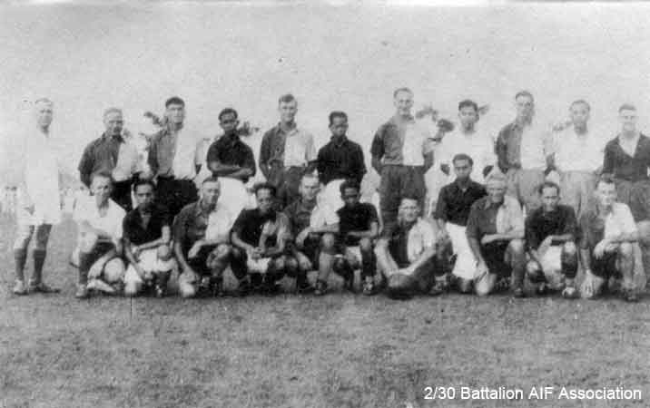 Batu Pahat and 2/30 Battalion Soccer Teams
The Batu Pahat and 2/30 Battalion soccer teams, which played against each other on the padang at Batu Pahat in late 1941.

The Battalion soccer team normally wore white shirts, but as the Batu Pahat team also played in white, the Battalion chose to wear the 2 tone "A" Company jerseys.

The game finished in a 2 all draw. Batu Pahat's 2 goals were scored by their inside left, who was a Malayan International. Jack Salisbury scored the Bn's first goal and George Stephenson scored the equaliser.

Left to right:

Back row (standing):
1)
2) NX25780 - GODLEY, David (Scotty), Pte. - HQ Company, Carrier Platoon
3) NX24089 - HARRIS, John Evan (Scotty or Cock), Cpl. - HQ Company, Mortar Platoon
4) 
5) NX54467 - STONE, Eric William (Ric), Cpl. - HQ Company, Mortar Platoon (Captain)
6) 
7) NX36453 - MABEN, Roland Robert (Roly), Pte. - HQ Company, Mortar Platoon
8) 
9) NX45174 - LONIE, John Graham (Jack), Pte. - HQ Company, Signals Platoon
10) 
11) NX27159 - WHITE, George Harold (Doughy), Cpl. - BHQ, Cook HQ Coy (Goalie in black shirt)

Front row (kneeling):
1) NX26865 - POPE, John Sidney Malcolm (Jack), Pte. - C Company, 15 Platoon (Linesman)
2) 
3) NX36564 - STEPHENSON, George, Pte. - HQ Company, A/A Platoon
4) 
5) NX20550 - McLEOD, Thomas Kennedy (Tom), A/Cpl. - B Company, 10 Platoon
6) 
7) NX34411 - SOUTHWELL, Colin Leslie (Les), Pte. - A Company, 7 Platoon
8) 
9) NX54474 - STEVENS, Francis Rupert Brotherson (Snowy), Pte. - HQ Company, Mortar Platoon
10)
11) NX53054 - SALISBURY, John Edward (Jack), L/Cpl. - A Company, 7 Platoon
Keywords: Makan267