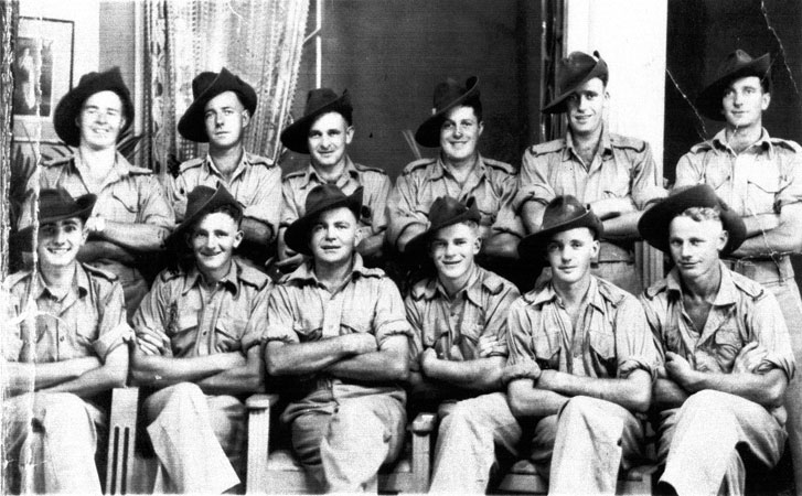 D Company, 18 Platoon 
Some of 18 Platoon "D" Company. Photo taken at Batu Pahat, Christmas 1941.

The photo was taken by a commercial photographer at Batu Pahat, who operated under the name Ma Lee. He showed up later in Singapore as a Japanese officer. Spies and fifth columnists were everywhere.

Left to right:

Back row:
1) NX2536 - UPCROFT, Ernest Bruce (Bruce), Pte. - D Company, 18 Platoon
2) NX60594 - STUART, Lloyd Thomas, Pte. - D Company, 18 Platoon
3) NX47833 - WEST, Jack Sydney (Jackie), Pte. - D Company, 18 Platoon
4) NX47505 - MORGAN, Gordon Russell (Tommy), Pte. - D Company, 18 Platoon
5) NX51831 - GALBRAITH, William Martin (Bill), Pte. - D Company, 18 Platoon
6) NX51660 - CAREY, John Peter (Jack), Pte. - D Company, 18 Platoon

Front row:
1) NX37732 - PHILLIPS, Ernest William (Ernie), Pte. - D Company, 18 Platoon
2) NX47685 - WELLS, Robert Frederick (Hook or Bob), Pte. - D Company, 18 Platoon
3) NX47597 - HOGAN, Martin Leo (Leo), Pte. - D Company, 18 Platoon
4) NX47761 - JONES, Baden Stanley (Sluggo), Pte. - D Company, 18 Platoon
5) NX10661 - CAREY, Luke Robert, Pte. - HQ Company, Mortar Platoon
6) NX47750 - BRACE, Albert Ernest (Snowy), Pte. - D Company, 18 Platoon 
Keywords: 090811a