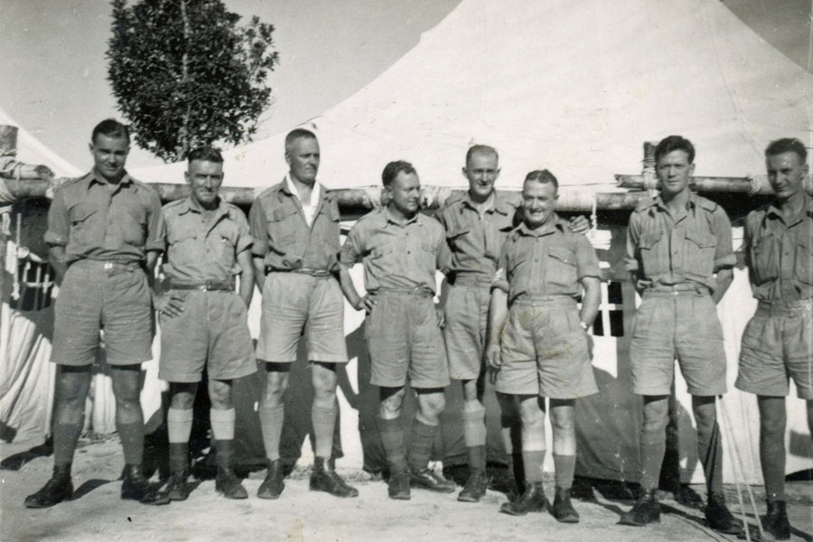 In camp in Malaya
In camp in Malaya. Annotated on reverse: The Lads who make the wheels go round. Signed by from left to right: W H Skene, H McKeeley, W Heydon, H J Daley, J B C(illegible), J (illegible), W H Harvey and E Berry.

Left to right:
1) NX30114 - Pte. William Hartridge (Bill) SKENE - C Company, 14 Platoon
2) H McKeeley
3) W Heydon
4) H J Daley (possibly NX50577 - Sgt. Harley James DALEY - 2/20 Bn.)
5) J B C(illegible)
6) J (illegible)
7) W H Harvey
8) E Berry 
Keywords: 20120722 NX30114