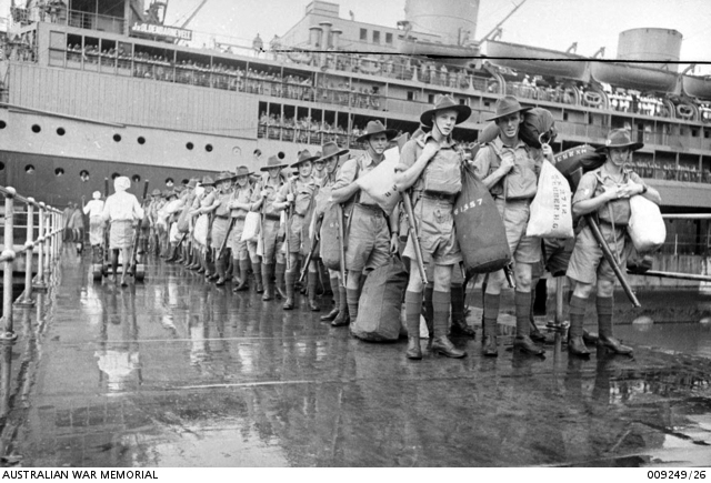 Arriving in Singapore
Members of "C" Company, 2/30 Battalion disembark at Singapore, from Johan Van Oldenbarnevelt (HMT FF), part of Convoy US11B.

First row - nearest to camera:
1) NX41357 - CAMERON, Alan Rentoul, Lt. - C Company, O/C 15 Platoon
2) NX2712 - WEBBER, Harry George, L/Cpl. - C Company, 15 Platoon (with pack on left shoulder)
3) NX2538 - JOHNSTON, Ronald Athol (Ron), Cpl. - C Company, 14 Platoon 
Keywords: 20131118a Johan