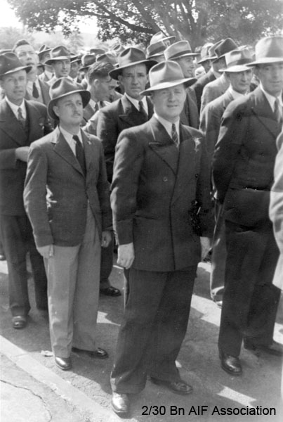 Anzac Day, Sydney, 194?
This photo was probably taken at an Anzac Day march in Sydney in the late 1940's. Some of the men are wearing rosemary in their lapels, as by that stage, they had not been issued with their medals.

Closest to camera (dark coloured suit wearing a hat):
NX32306 - MACIVER, Donald Gunn (Bluey), Cpl. - HQ Company, Mortar Platoon

3rd row (without a hat, looking down towards the ground, and to the left):
NX2501 - OVERETT, Arthur George McKay, Pte. - BHQ. Battalion Store
Keywords: AnzacDay