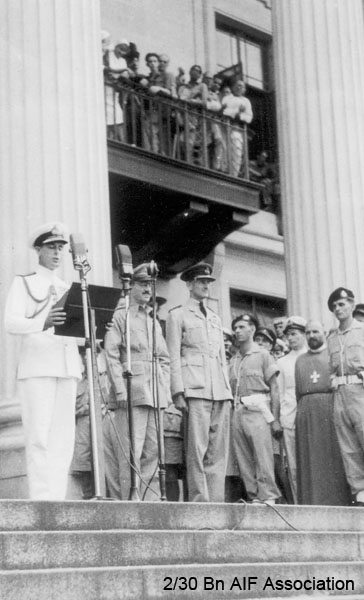 Japanese surrender, Singapore, 1945
Admiral Mountbatten giving a public address on the steps of the Singapore Municipal Buildings during the Japanese surrender ceremony. To the right of Mountbatten are Lieut. General Wheeler and Air Chief Marshal Sir Keith Park.
Keywords: Surrender