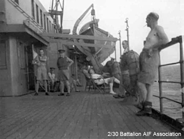 On the way to Singapore
On board  Johan Van Oldenbarnevelt (HMT FF)

Left to right:
Standing:
1) NX70454 - BAYNES, Vernon, Lt. - D Coy.
2) Unknown

Leaning against ship's rail:
1) Unknown
2) Unknown

Keywords: Johan