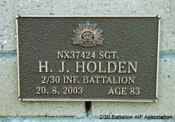 NX37424 - HOLDEN, Henry John (Harry), A/Sgt. - B Company, 12 Platoon
View of the bronze plaque erected in the NSW Garden of Remembrance on Wall 41, Row E. The garden is adjacent to Sydney War Cemetery at the Rookwood Necropolis, and is maintained by The Office of Australian War Graves.

The plaques are provided by The Office of Australian War Graves to commemorate eligible veterans who have died post war and whose deaths are accepted as being caused by war service. This form of commemoration is used when there is a private memorial elesewhere, or for some reason, the Office is unable to provide an official memorial at the relevant Cemetery or Crematorium.
