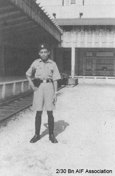 Guard at Singapore Railway Station, 1941
"A view of the railway station and one of the guardians of law and order that I managed to get to pose for me"
NX72575 - CONN, Edward John (Jack), Pte. - HQ Company, Signals Platoon
Keywords: NX72575