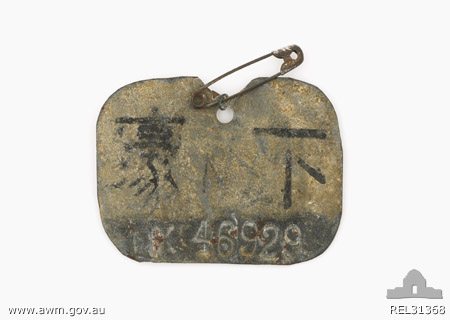 POW Identity Tag - NX46929 - Cpl. W. Middleton
Australian War Memorial caption reads:
Physical description:
Galvanized iron; Japanese issued prisoner of war identity tag worn by Corporal William Middleton of 2/30 Battalion, AIF. The roughly cut rectangular tag is made of thin galvanized metal with Japanese characters which translate as 'Australia' and 'NCO' painted on it. Below these is stamped an Australian Army service number 'NX46929'. At the centre top of the tag is a hole with a short length of wire twisted through it. A safety pin is attached to this wire loop.

Summary:
William Middleton was born at Taree, NSW, in April 1905. He enlisted in the 2nd AIF in July 1940, becoming Corporal NX46929 in 2/30 Infantry Battalion, part of the 8th Australian Division, which was sent to defend the Malay peninsula. After heavy fighting in Malaya, (including the successful ambush of advancing Japanese forces at Gemas on 14/15 January 1942) 2/30 Battalion surrendered with the rest of the 8th Division at Singapore on 15 February 1942, and went into captivity. Middleton would have been issued with this tag, identifying him as an Australian NCO, by the Japanese authorities. He survived captivity, but was in very poor health when repatriated to Australia aboard the Dutch hospital ship 'Oranje'. He was not expected to survive the voyage, and gave his ID tag to New Zealand Nursing Sister NZ823214 Mary Langford, who was serving on the 'Oranje'. Official records indicate, however, that he recovered, and was considered healthy enough to be discharged from the army in March 1946. His later movements are not known.

NX46929 - MIDDLETON, William, A/U/Sgt. - BHQ. Band. Concert Party Orchestra Leader
Keywords: 100105c