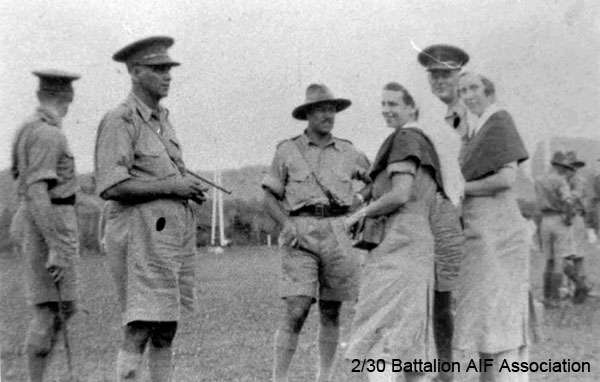 Sports Day at Batu Pahat
Battalion sports day on the Padang at Batu Pahat

Left to right:
1) NX76207 - PEACH, Francis Stuart Banner (Stuart), Col. - BHQ. Adjt. MiD OBE. 1963. ED, ToS 28/7/1941
2) NX70416 - GALLEGHAN (Sir), Frederick Gallagher (Black Jack), Brig. - BHQ. CO. 2/30 Bn. D.S.O., O.B.E., I.S.O., E.D., K.B.
3) NX70440 - BOOTH, Lyndon Harold (Lyn), Lt. - A Coy. O/C 7 Pl. WiA Gemas
4) Sister BALFOUR-OLGIVIE
5) Sister KINSELA
6) Brig. MAXWELL
Keywords: BattalionFirstAniversary