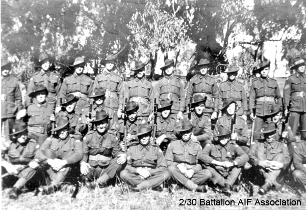 A Company, 9 Platoon
Bathurst, June 1941.

Left to right:
Back row:
1) NX67414 - ROWE, Rex William, A/U/WO2 - A Coy. CSM. MiD
2) NX27550 - WILSON, David Royce (Doc), A/Cpl. - A Coy. 9 Pl. 
3) NX30528 - KORN, John Joseph (Jack), Pte. - A Coy. 9 Pl. 
4) NX2578 - HANN, Ross Mervyn, Pte. - A Coy. 9 Pl. 
5) NX46443 - McFARLANE, Cyril Keith (Keith), Pte. - A Coy. 9 Pl. 
6) NX30642 - TAIT, Francis Earl (Earl), Cpl. - A Coy. 9 Pl. Doi Sonkurai 3 (Gangrene, Beri Beri)
7) ? - PITT, K.J.
8) NX29189 - JAMES, Ronald Taylor (Ron), Pte. - A Coy. 9 Pl. attempt escape MpD, Sonkurai 1
9) NX54877 - WEBSTER, Leslie (Les), Pte. - D Coy. MpD Gemas
10) NX33559 - HELLMRICH, Thomas Frederick (Tom), Lt. - A Coy. 9 Pl. OTS. Bathurst. did not sail

Middle row:
1) NX30203 - JONES, Robert Frederick Vaughan, Pte. - A Coy. 9 Pl. Repatriated 15/11/1941; medically unfit Synovitis
2) NX31528 - JOHNSON, Allan Alfred (Ack Ack), Pte. - HQ Coy. Sig. Pl. 
3) NX31671 - SOMERVILLE, James (Jim), Pte. - A Coy. 9 Pl. Doi Sonkurai 3 (Heart Failure)
4) NX31047 - O'CONNELL, James (James Patrick) (Paddy), Pte. - A Coy. 9 Pl. 
5) NX30547 - TUCKER, Sydney Edward (Sid), Pte. - A Coy. 8 Pl. Doi Sonkurai 3 (Cardiac Beri Beri)
6) NX4416 - SWAIN (Swanson), Victor Leonard (Vic), Pte. - A Coy.  Pl. WiA Gemas, Repatriated 10/2/1942
7) ? - MCLURE, F.
8) NX30772 - SIMPSON, John Francis (Curly), A/Cpl. - A Coy. 9 Pl. WiA Gemas

Front row:
1) NX57453 - HAMILTON, John Allan Reginald (Allan), Cpl. - A Coy. 9A Pl. WiA Gemas
2) NX60586 - O'MALLEY, John Michael (Jack), Pte. - A Coy. 9 Pl. 
3) NX29196 - MOONEY, Roy Ernest (Dryballs), Pte. - A Coy. 9 Pl. WiA Gemas
4) NX31018 - BRENNAN, Vincent Joseph (Vince), Pte. - A Coy. 9 Pl. WiA Gemas, Rep 10/2/1942
5) NX60583 - NOAKES, Ernest Francis (Frank), Pte. - A Coy. 9 Pl. Doi Sonkurai 1 (Cholera)
6) NX46367 - MARRIOTT, Ray Samuel (Joe Palooka), Pte. - A Coy. 9 Pl. was Carrier Platoon, transferred to A Coy at Bathurst
7) NX41394 - PARSONS, John Thomas (Jack), Pte. - A Coy. 9 Pl. Doi Tanbaya (Dysentery, Beri Beri)
8) NX47564 - DOWLING, Kevin John, Pte. - A Coy. 9 Pl. 
Keywords: NX2578HANN