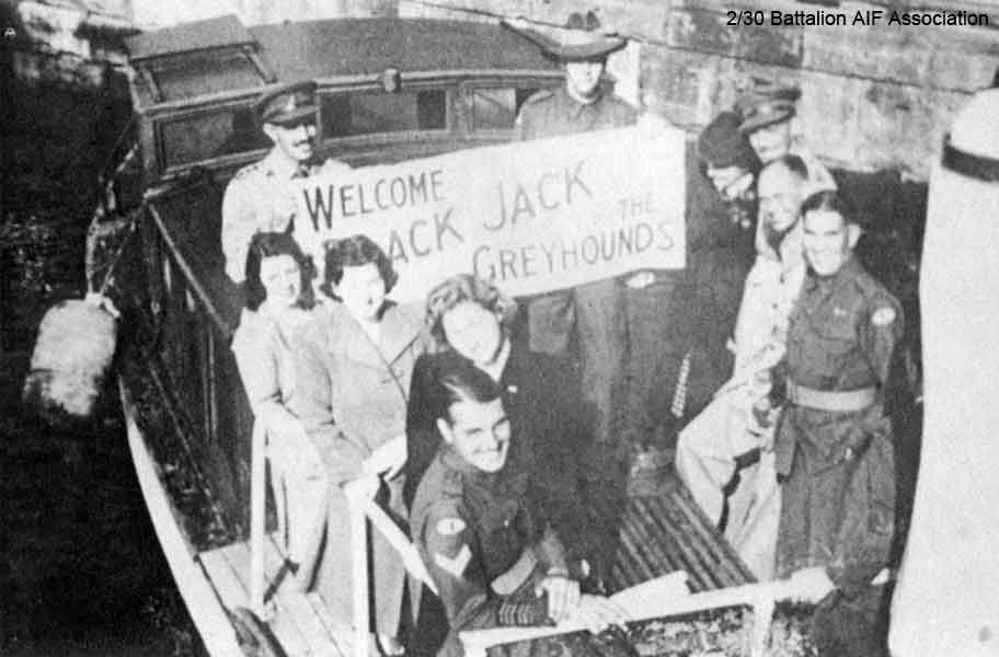 Welcome Black Jack and The Greyhounds
A group of 2/30 Bn. veterans, relatives and friends on board a small launch on Sydney Harbour to welcome home other Battalion members who had returned to Australia on board Esperance Bay.

Two of the group are holding a banner made by Roy Chipps - "Welcome Black Jack and The Greyhounds". Roy was the father of NX24742 - Pte. Ron CHIPPS, who had returned to Australia a few weeks earlier on board the hospital ship, Oranje.

Holding the banner:
Left: NX70437 - KEARNEY, Peter Desmond (Black Prince), Capt. - B Coy. 2 l/c B Coy.
Right: Unknown

Left hand side:
1) Unkown
2) Sister of Ron Chipps
3) Sister of Ron Chipps
4) Cpl. ?

Right hand side:
1) Unknown
2) Unknown
3) Unknown
4) Unknown
Keywords: NX70437, NX24742
