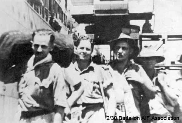 Waiting to board at Singapore
Homeward bound waiting to board Esperance Bay at Singapore on 22nd September, 1945.

Left to right:
1) NX55521 - TREVOR, Terence Charles (Terry), Pte. - B Company, 11 Platoon
2) NX2536 - UPCROFT, Ernest Bruce (Bruce), Pte. - D Company, 18 Platoon
3) Unknown
4) Unknown

also identified by Tom Grant as:

1) NX47008 - SILVER, Frank Michael, Pte. - C Company, 15 Platoon *
2) NX37702 - BICKNELL, Thomas John, L/Cpl. - C Company, 15A Platoon *
3) NX27451 - GRUBB, Ronald Wilfred, Pte. - D Company, 17 Platoon *
4) Unknown

* Identified by Tom GRANT, Makan 231, Dec. 1976
